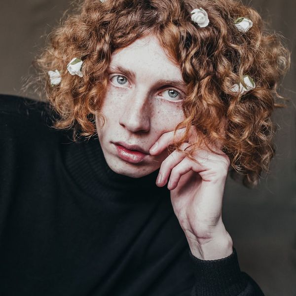 Person smiling gently while looking at a beautiful natural landscape.