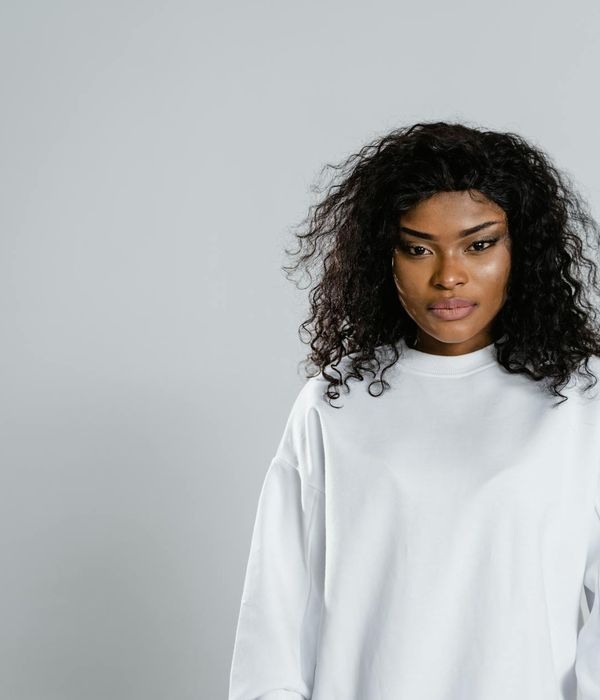 Woman with a calm and focused expression looking forward.